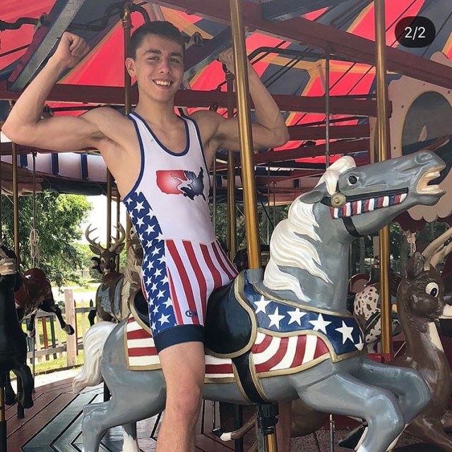Wrestler in American flag singlet on a carousel.